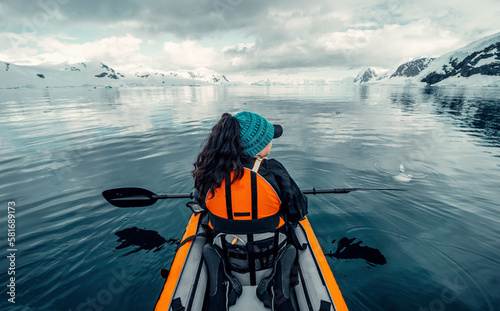 Female Kayaker Paddling in Calm Waters of Antarctica, Woman in Orange Life Vest, Looking At Scenic Views of Arctic landscape