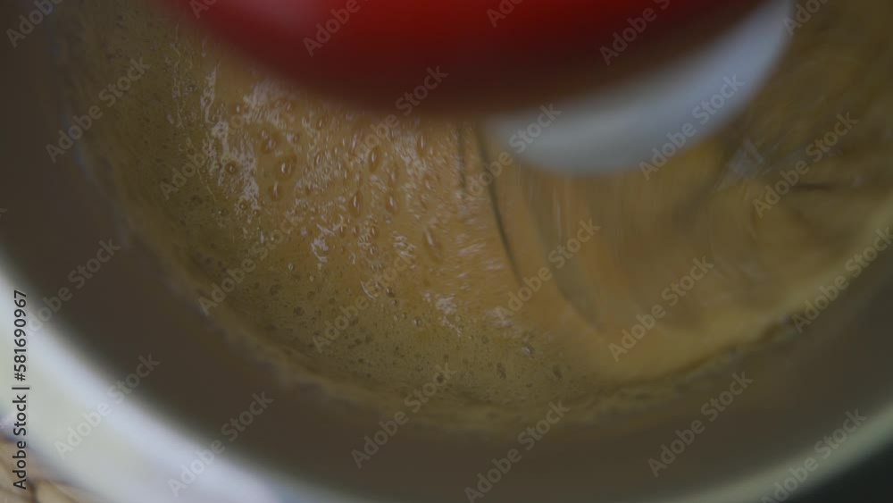 mixing egg ingredients in a stationary kitchen mixer. Cooking delicious cream for the cake. mixing egg ingredients in a stationary kitchen mixer. Cooking delicious cream for the cake.