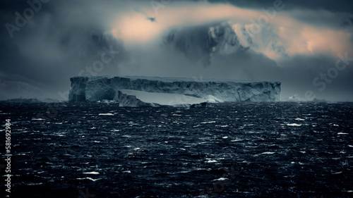 Scenic Landscape of Huge Rectangular Iceberg In Antarctica Shows Signs of Calving, Moody and Misty © David