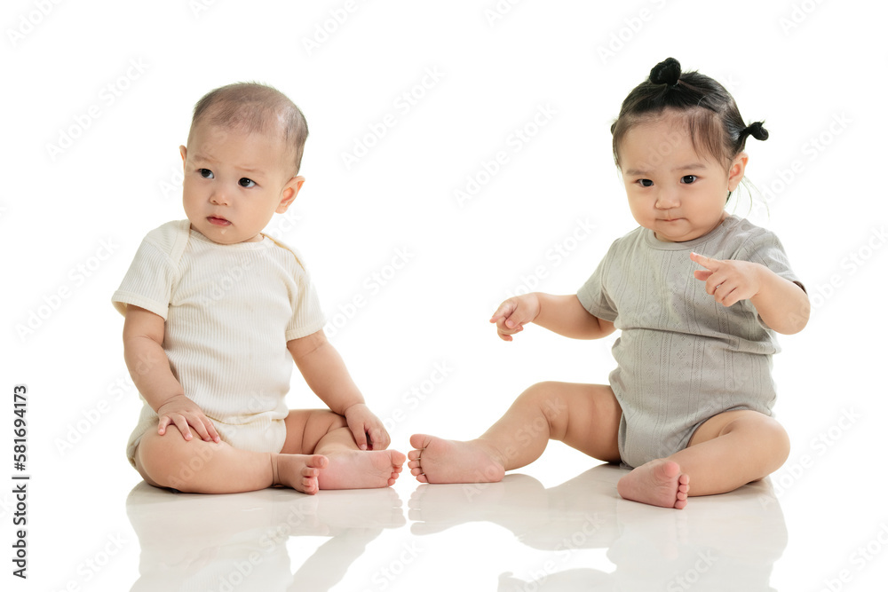Playing two cute baby sitting on the ground Playing two cute baby sitting on the ground
