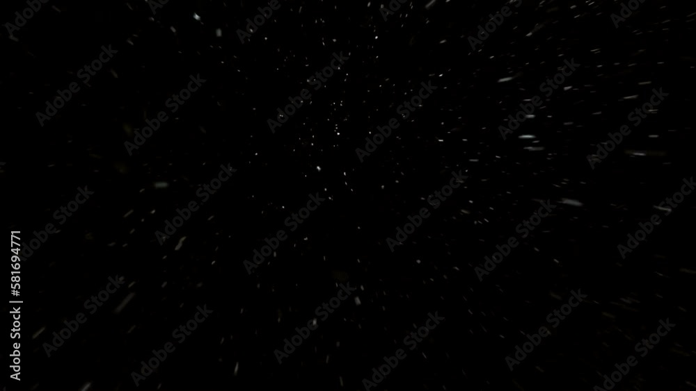 Bottom view of falling snowflakes from the sky. Real snowflake on a black background. Winter snowfall. Bottom view of falling snowflakes from the sky. Real snowflake on a black background. Winter snowfall.
