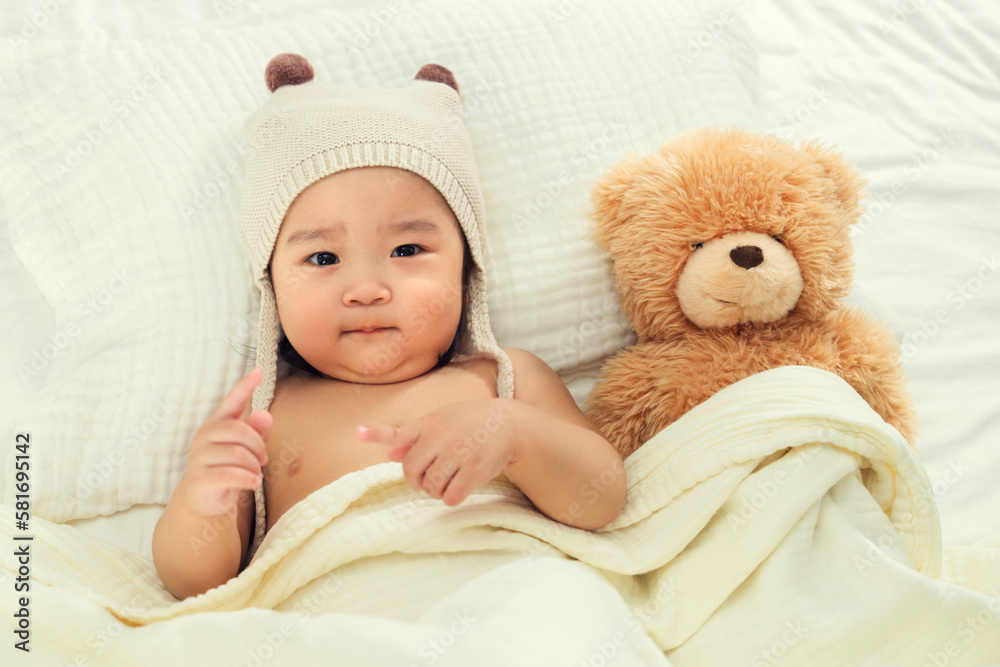Lovely baby girl lie on the bed to play Lovely baby girl lie on the bed to play