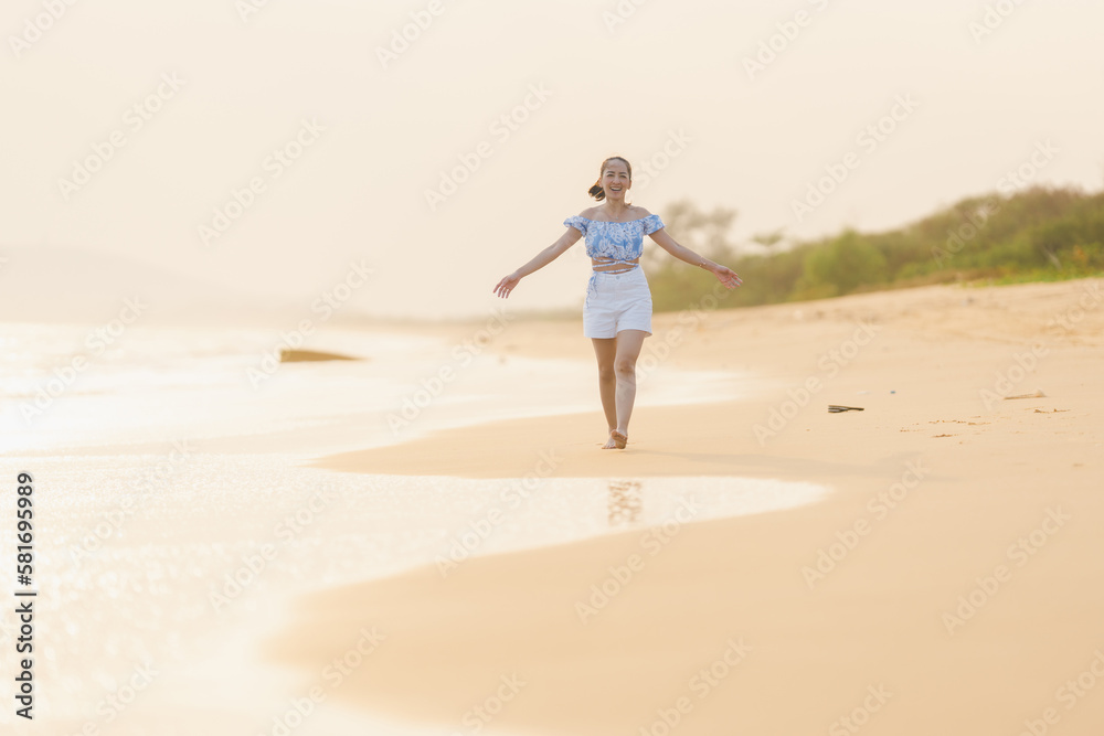 happy time of woman walking and run play on the beach with blur background beautiful sunset light in the sea happy time of woman walking and run play on the beach with blur background beautiful sunset light in the sea