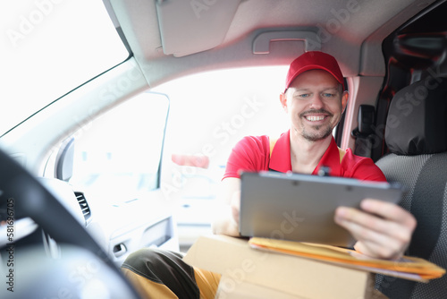 Courier is engaged in logistics of delivery and holds tablet