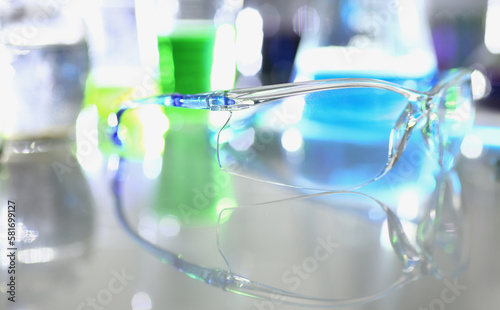 Transparent glasses and chemical liquids in test tubes in laboratory