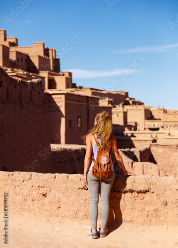 Woman tourist looking at Kasbah, Ait ben haddou, Ouarzazate in Morocco