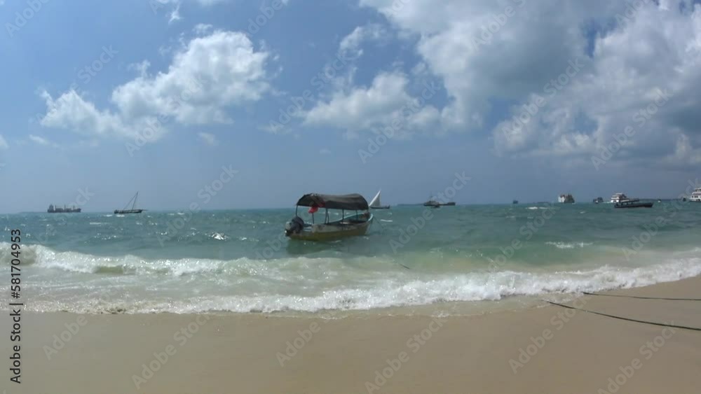 A traditional Zanzibar boat in the waves near the beach. Stone Town, Zanzibar City. A traditional Zanzibar boat in the waves near the beach. Stone Town, Zanzibar City.