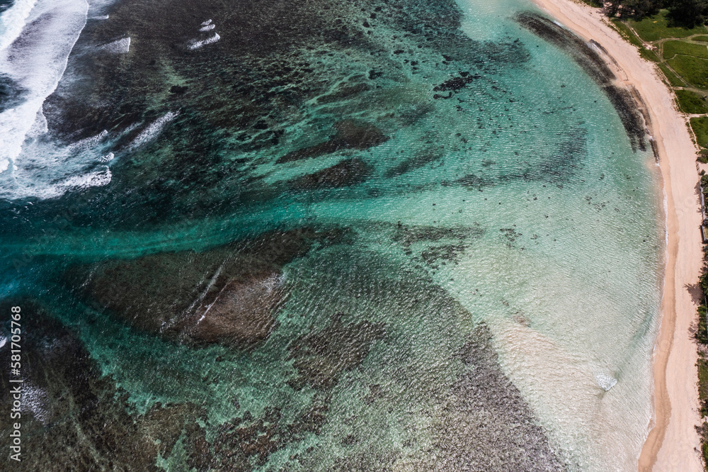 Aerial landscape tow view of beach and oceanic coastline with a reef who protects the Island and the beach