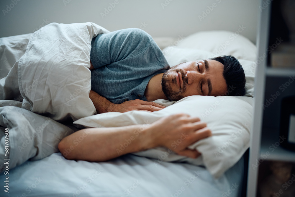 Peaceful man sleeping in bedroom. Peaceful man sleeping in bedroom.