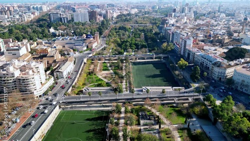 Hyperlapse of the 9km long park located in the center of valencia in spain , this shows the highways down both sides with building, and the lush green park running down the middle of the city photo