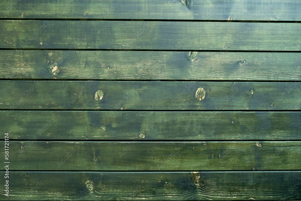 Fototapeta premium Green wall of an old wooden house
