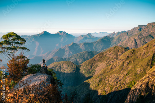 Woman standing shouting on the cliff of Echo Point in Kodaikanal, India