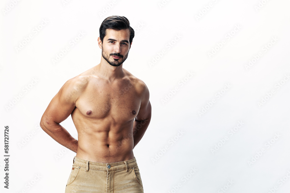 Man athlete model with a naked torso and six pack abs sporty inflated figure and tan on a white isolated background, fashionable clothing style, copy space, space for text Man athlete model with a naked torso and six pack abs sporty inflated figure and tan on a white isolated background, fashionable clothing style, copy space, space for text