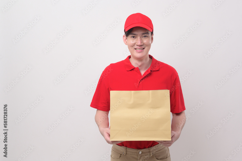 Asian Young delivery man wearing  red uniform on  white background studio