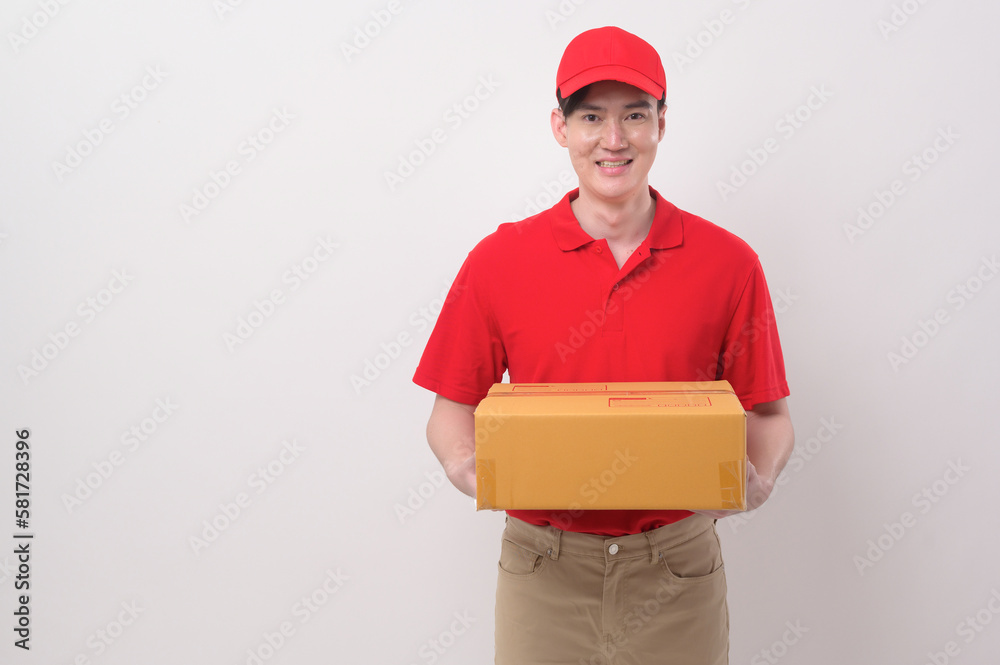 Asian Young delivery man wearing red uniform on white background studio Asian Young delivery man wearing red uniform on white background studio
