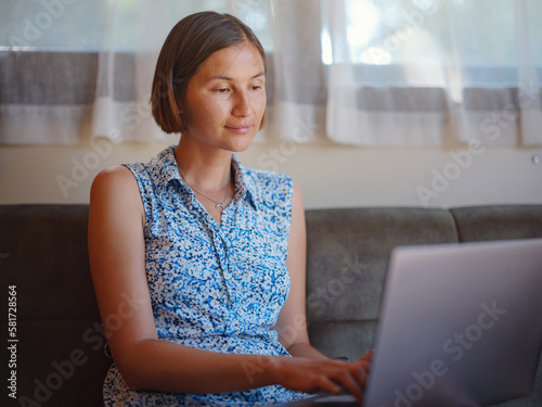 Free Download Beautiful lady work on notepad sit on sofa at home - check online shopping for cyber monday sales - technology woman concept for alternative freelance office - GFXLoad