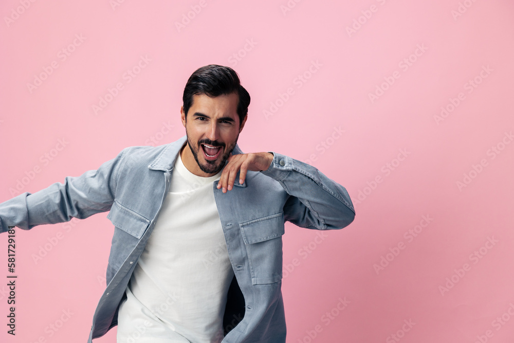 Stylish brunette man with beard happiness open mouth jumping and running spreading his arms on a pink background in a white T-shirt and jeans smile and joyful emotion on his face, copy space Stylish brunette man with beard happiness open mouth jumping and running spreading his arms on a pink background in a white T-shirt and jeans smile and joyful emotion on his face, copy space