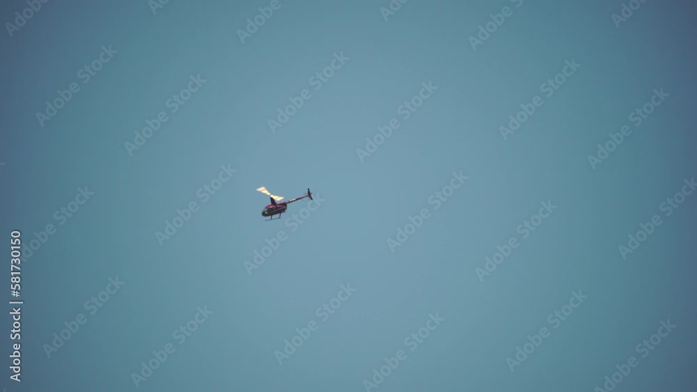 Modern helicopter fly in sky, as viewed from the ground. Silhouette of