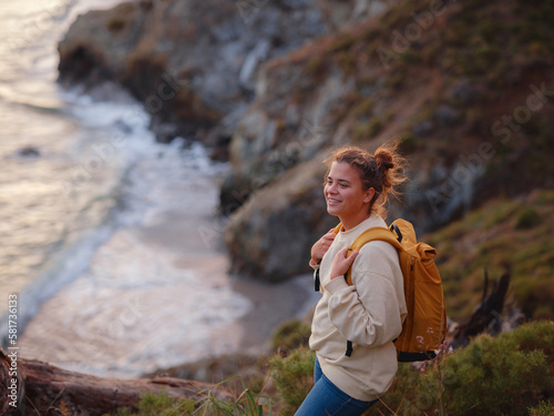 Travel and active lifestyle concept. Happy smiling woman hiking in mountains , Fethie, Turkey. Young female hiker smiling, sport and trekking in autumn or spring nature, in holiday beach vacation trip