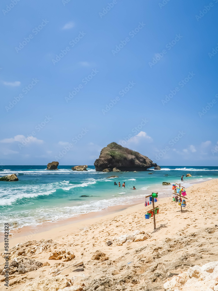 Tropical rocky beach with white sand and cliffs and blue sky with clouds on Sunny day. Summer tropical landscape, panoramic view. travel tourism wide panorama background concept. 