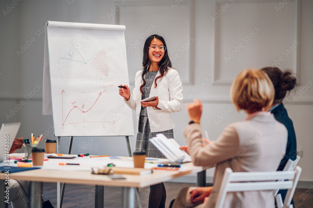 Asian businesswoman holding a presentation during a meeting in an office