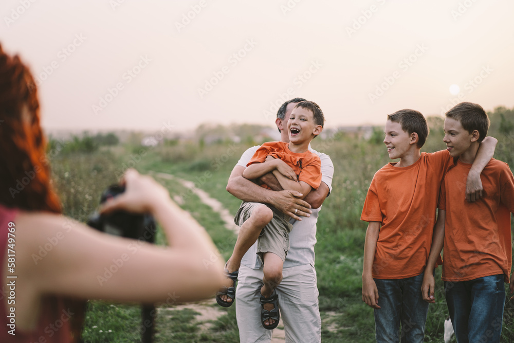 Portrait of a family in nature. Children and parents play in nature. Good time with family on vacation
