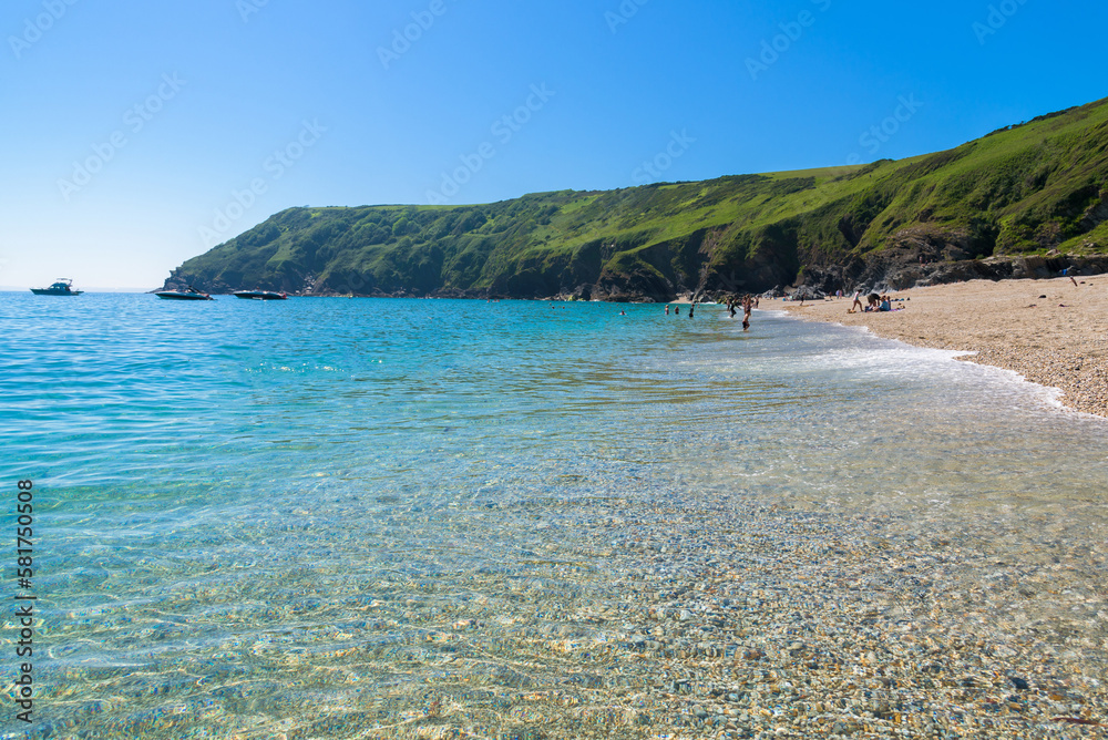 Stunning coastline and beach at Lantic Bay. Crystal clear turquoise sea water in Cornwall, England.