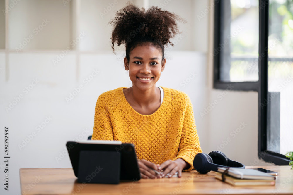 African american student woman in sweater using digital tablet t African american student woman in sweater using digital tablet t