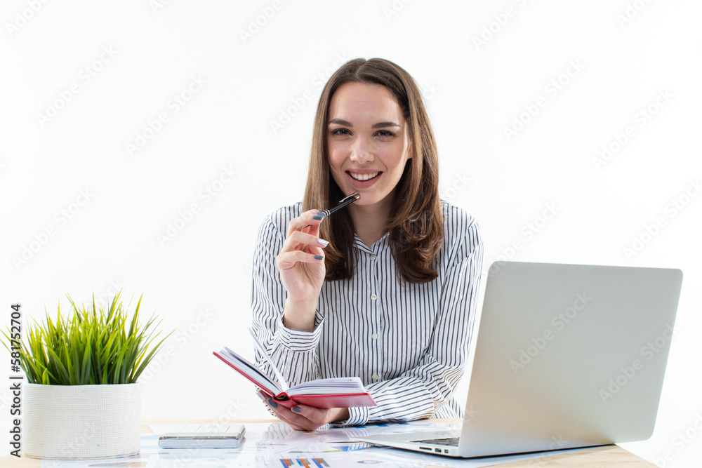 This modern businesswoman is hard at work, juggling multiple tasks as she efficiently manages her laptop and documents This modern businesswoman is hard at work, juggling multiple tasks as she efficiently manages her laptop and documents