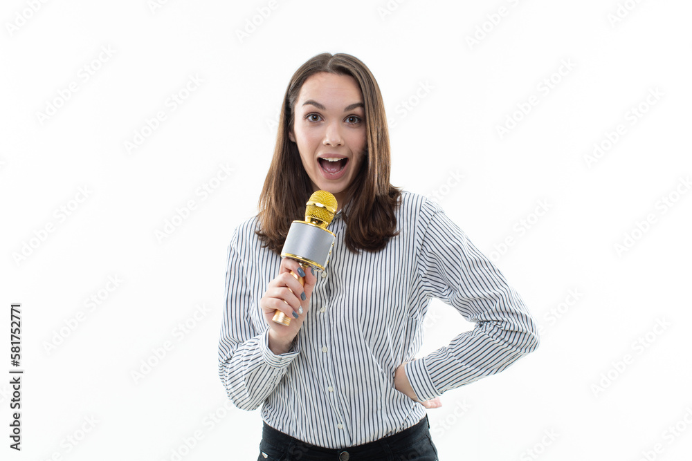 Smiling brunette sings into a microphone on a white background Smiling brunette sings into a microphone on a white background