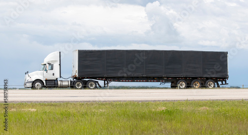 A highway truck hauling freight along a highway. Taken in Alberta, Canada © Stefon Linton