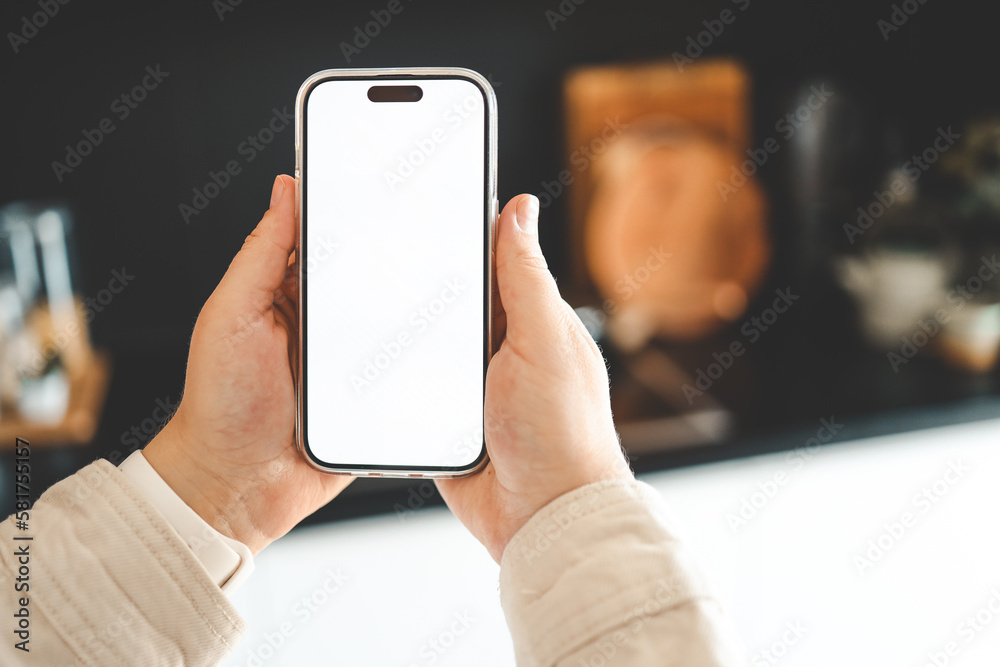 Hands with phone with isolated screen on kitchen background Hands with phone with isolated screen on kitchen background