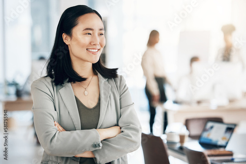 Asian, business woman and arms crossed with smile, thinking with leadership and professional mindset in workplace. Career, success and corporate female in Japanese office, happiness and confidence
