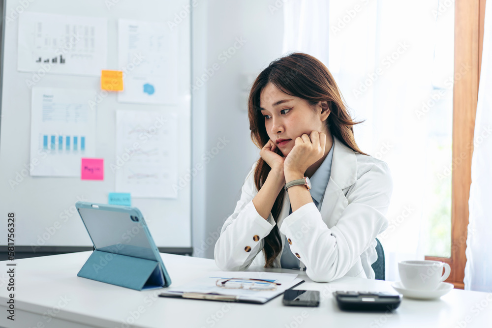 Businesswoman in suit is reading business data for thinking and Businesswoman in suit is reading business data for thinking and