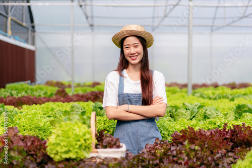 Woman smart farmer working and checking organic hydroponic vegetable quality in greenhouse plantation to management preparing export to sell © Katcha
