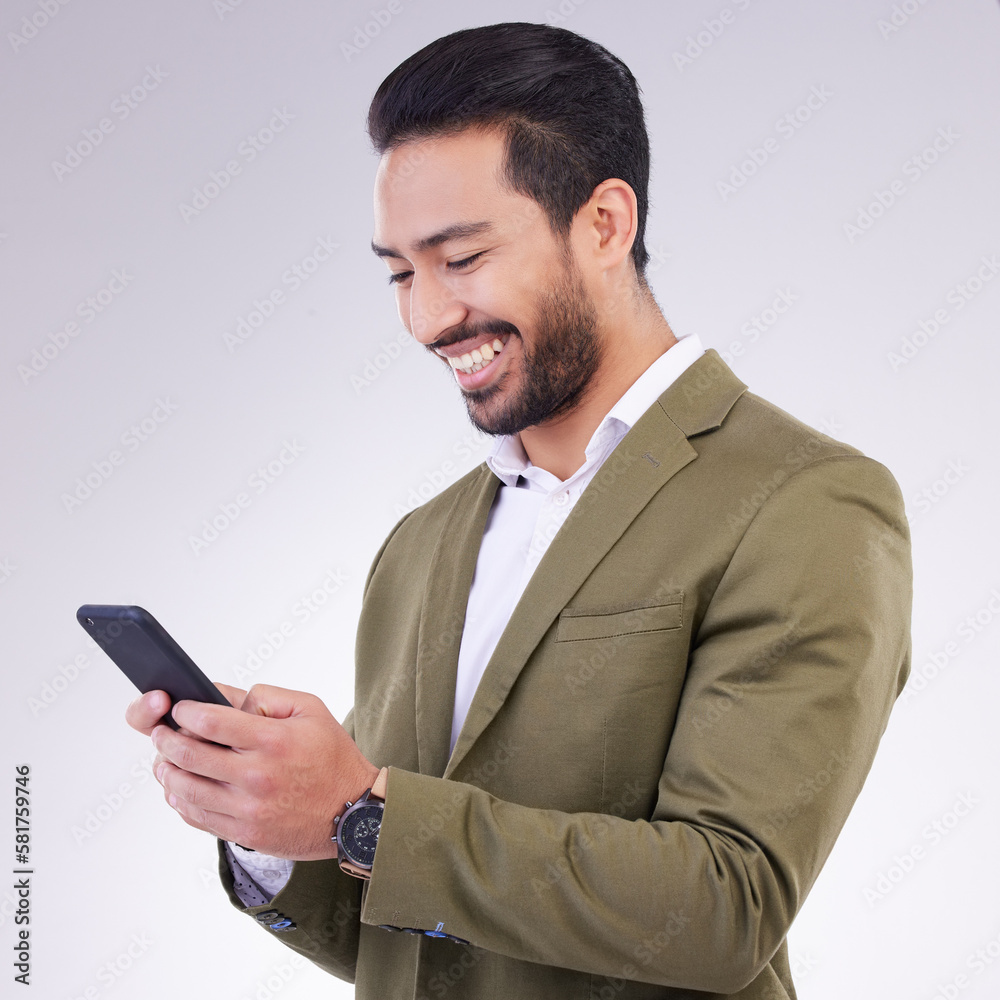 Business man, smile and phone for communication in studio while typing and networking on gray background. Asian male entrepreneur with smartphone for email, online chat or marketing on social media Business man, smile and phone for communication in studio while typing and networking on gray background. Asian male entrepreneur with smartphone for email, online chat or marketing on social media