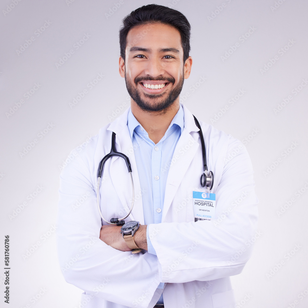 Doctor, man with arms crossed and happy in portrait, health and medical professional on studio background. Male physician, cardiovascular surgeon with stethoscope, happiness in medicine and mockup Doctor, man with arms crossed and happy in portrait, health and medical professional on studio background. Male physician, cardiovascular surgeon with stethoscope, happiness in medicine and mockup