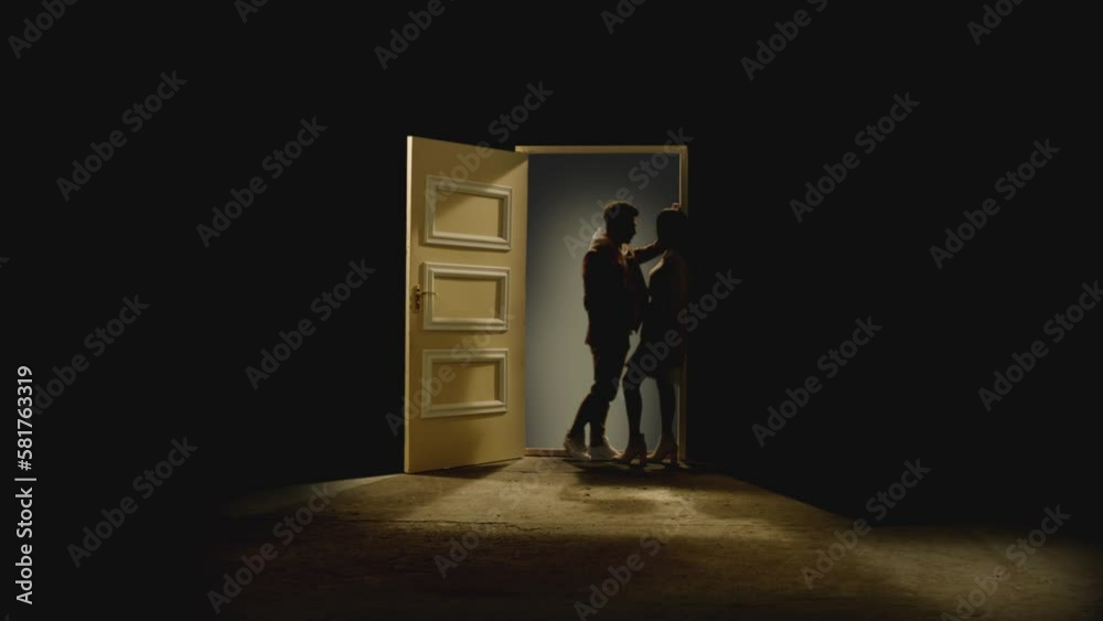 Side view of couple standing opposite and looking each other in front of an open door with galaxy behind . Footage of couple stand on floor behind stars. Concept of dream or romance . Slow Motion Side view of couple standing opposite and looking each other in front of an open door with galaxy behind . Footage of couple stand on floor behind stars. Concept of dream or romance . Slow Motion