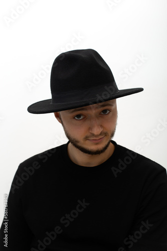 young man wearing a hat  seriously looking