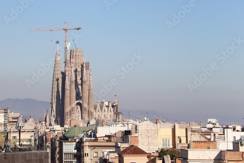 A view at Sagrada Familia from Casa Mila called La Pedrera from the street, Barcelona, Spain photo