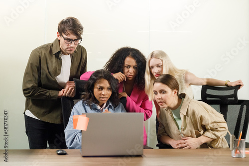 worried business man and woman colleagues looking at computer trying to solve problems in office