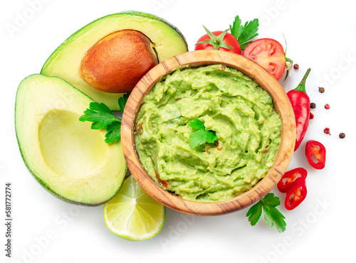 Guacamole bowl and guacamole ingredients isolated on white background. Flat lay.