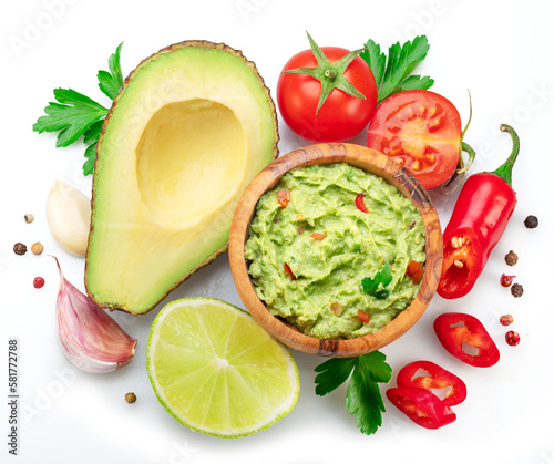 Guacamole and guacamole ingredients isolated on white background. Flat lay.