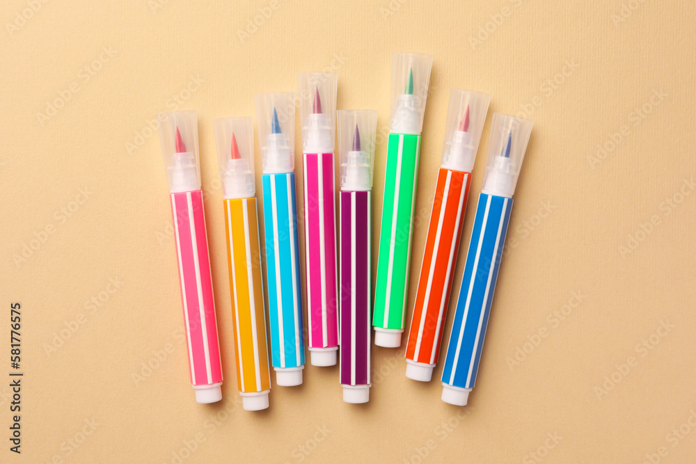Many bright markers on beige background, flat lay Many bright markers on beige background, flat lay
