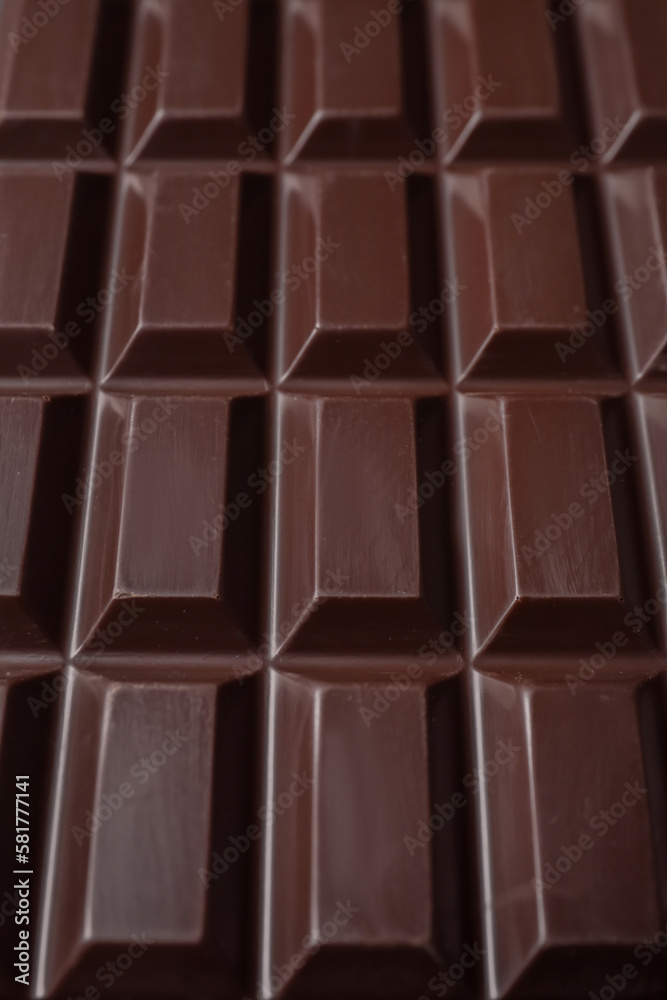 Delicious dark chocolate bar as background, closeup