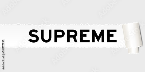 Ripped gray paper background that have word supreme under torn part