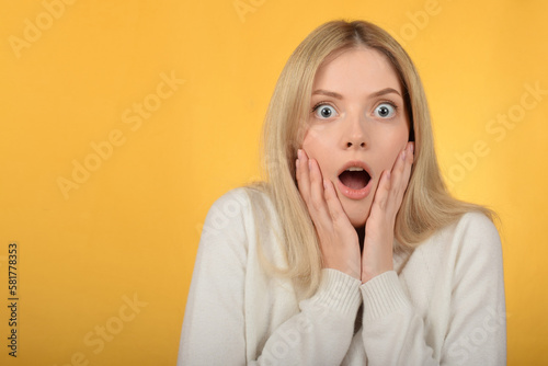 cute woman on yellow background surprised expression
