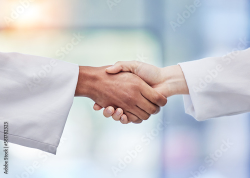 Doctors, handshake and healthcare partnership in agreement, teamwork deal or collaboration. Medical professionals shaking hands in meeting, greeting and success of trust, thank you or consulting help