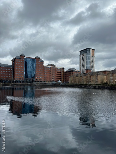 Modern buildings next to the river with reflections in the water. Salford Quays England. 