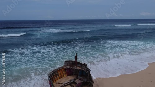 Aerial video of a shipwreck at Nunggalan Beach with photo